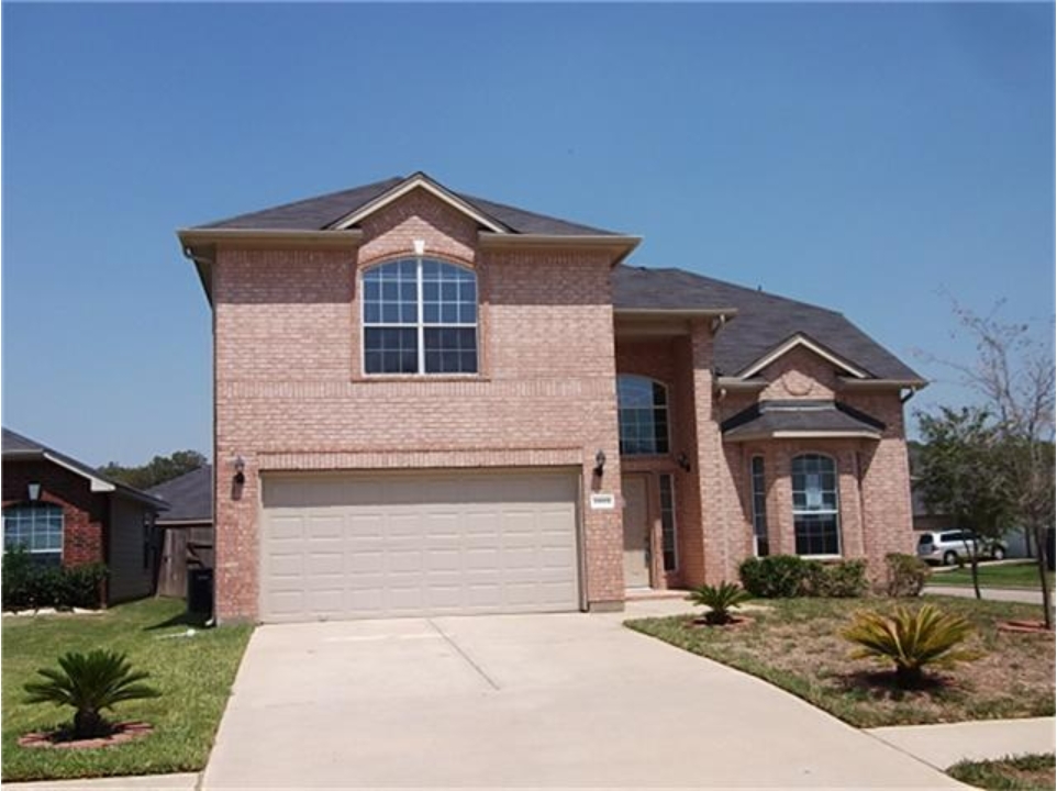 Two-story brick home with attached two-car garage